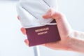 Passport pandemic vacation concept: Close up of fingers holding a passport, ffp2 protection mask, Ã¢â¬ÅReisepass Passport